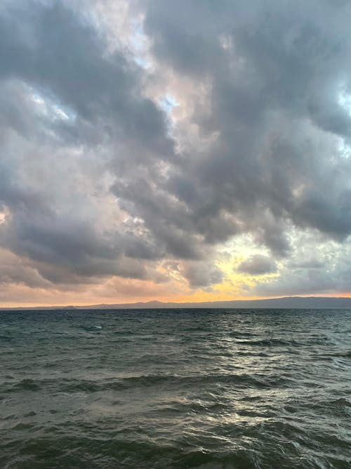 Free A Cloudy Sky over a Seascape Stock Photo