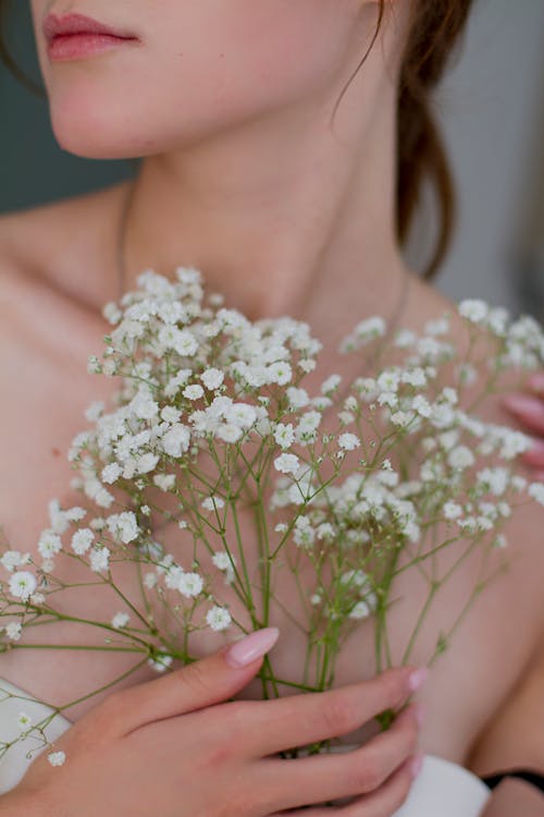 Woman Holding White Flowers