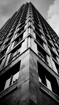 Dramatic low angle view of a sleek modern high-rise in The Hague, Netherlands.