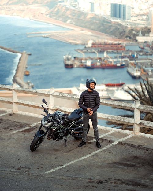 Man with a Motorbike in a Harbor 