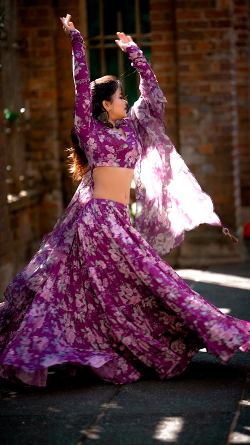 Woman in Purple Floral Dress Dancing