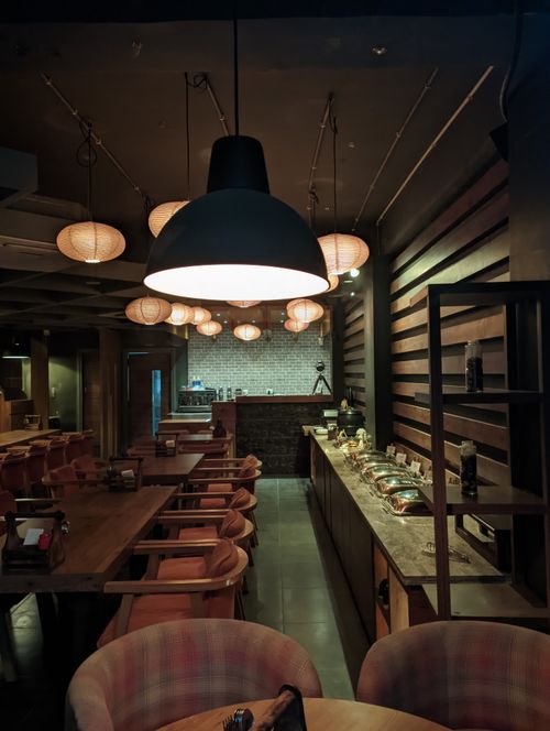 Free Warm interior of a restaurant featuring wooden furniture and ambient lighting. Stock Photo