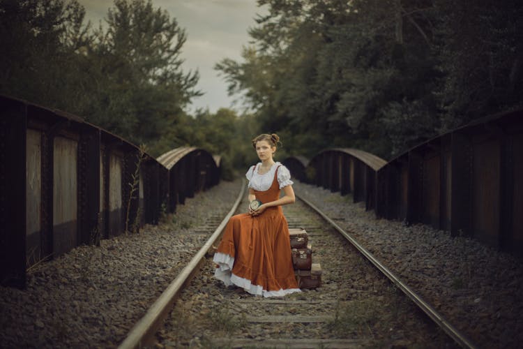 Woman With Clock On Railway