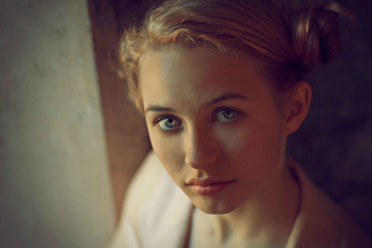 an artistic portrait of a young woman with a serene expression capture