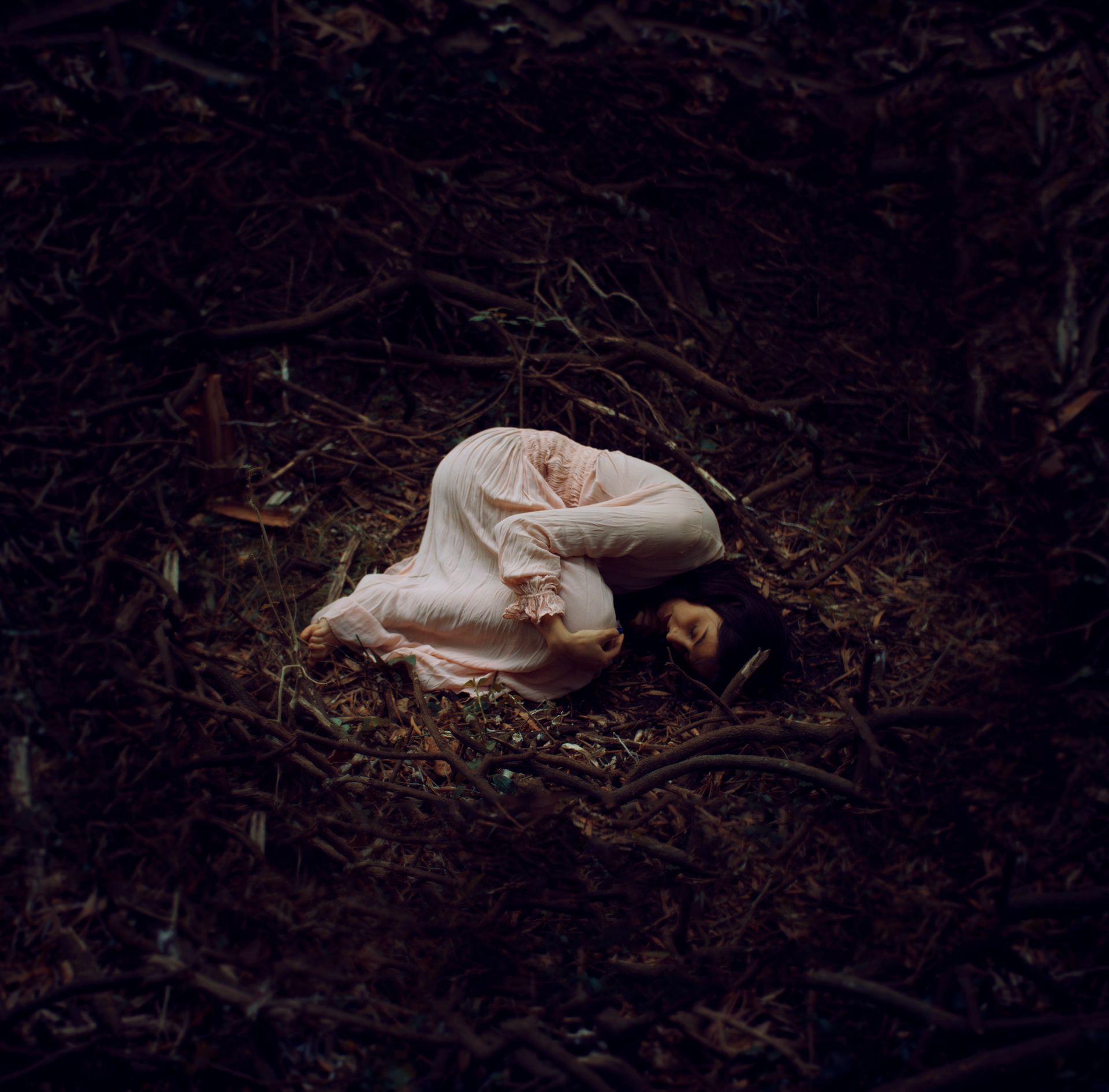 Woman in Dress Lying Down on Ground