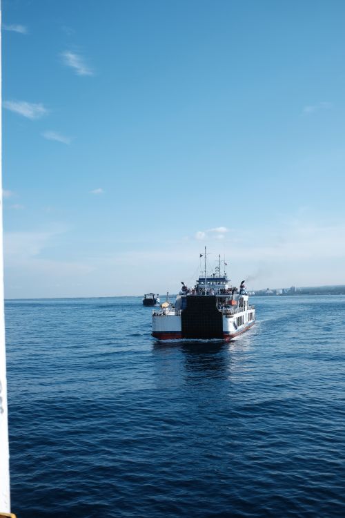 Free A ferry sails across the calm blue sea in Seattle, capturing the essence of travel and adventure. Stock Photo