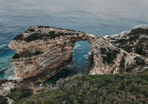 Free Breathtaking view of a natural rock arch over turquoise waters in Gaios, Greece. Stock Photo