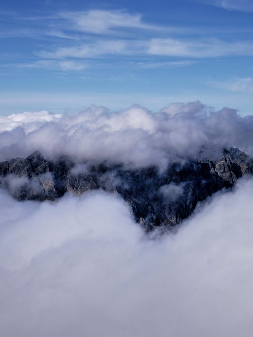 Free A breathtaking view of the Vysoké Tatry peaks surrounded by dramatic clouds in Slovakia. Stock Photo