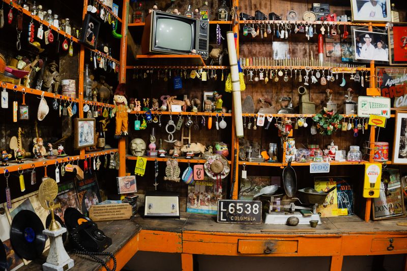 Shelf of assorted antique items and curiosities in a shop
