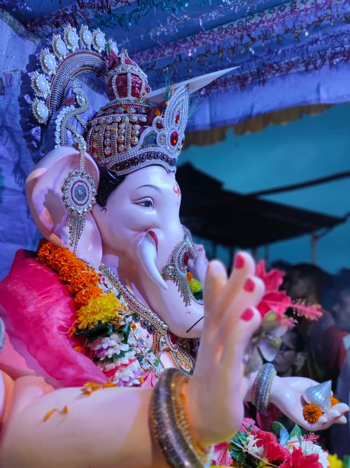 Free Vibrant Ganesha idol adorned with flowers at a cultural festival in Nagothane, India. Stock Photo