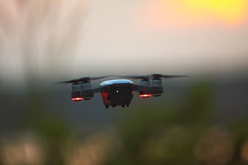 Selective Focus Photography of Red Quadcopter