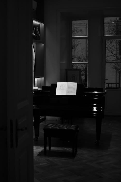 A Grayscale Photo of a Piano in a Room