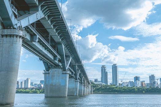 A scenic view of Cheongdam Bridge with Seoul's skyline in the background over the Han River.