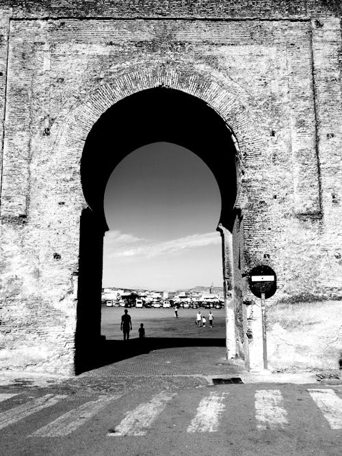 Grayscale Photo of an Arch
