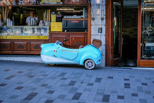 Charming ice cream shop with vintage vehicle in bustling Istanbul street scene.