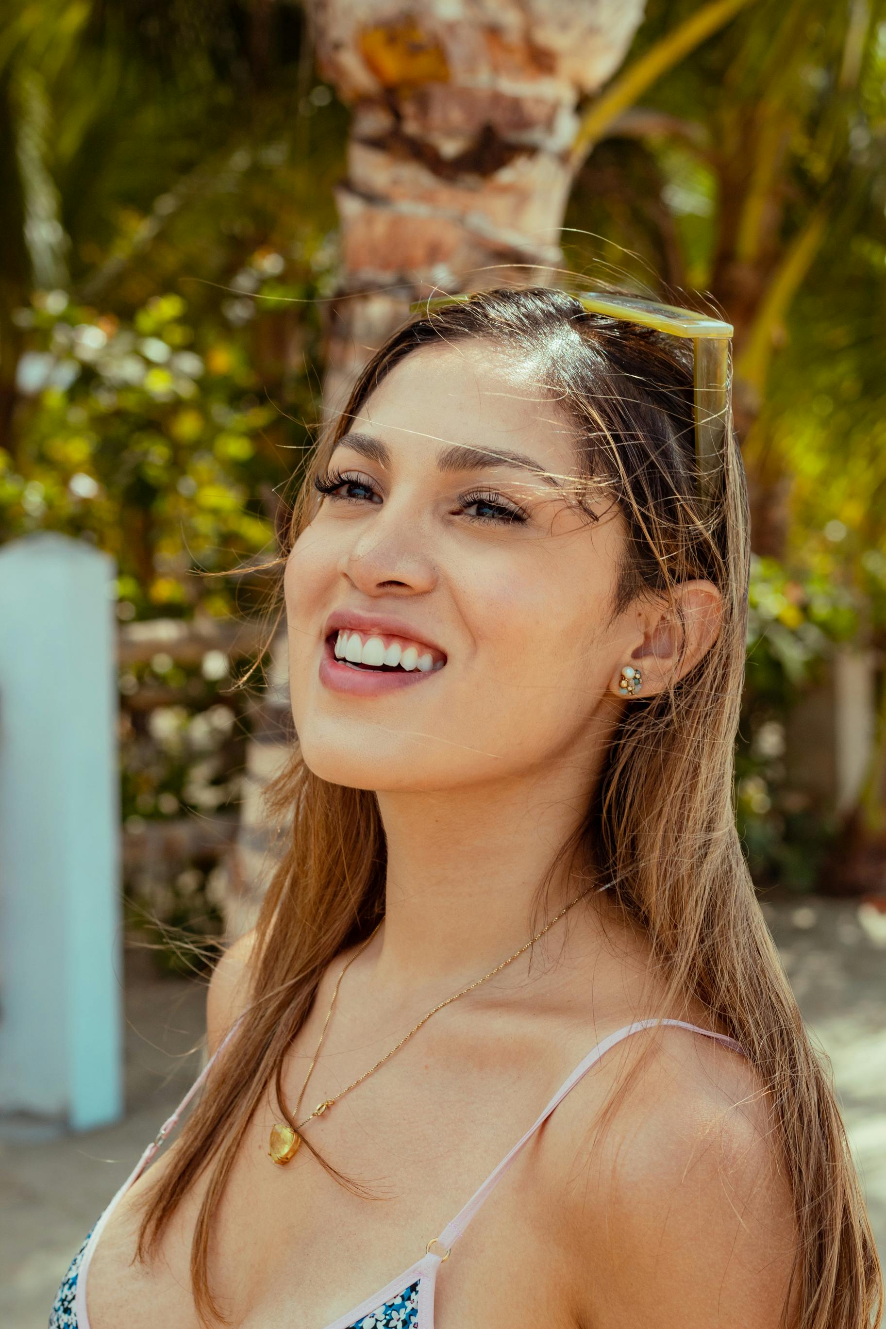 A joyful woman enjoys a sunny day outdoors in Salinas, Ecuador.