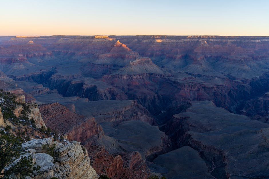 Grand Canyon Deluxe Helicopter Tour with Landing from Las Vegas - A breathtaking sunset view of the Grand Canyon's vast landscape and geological formations.