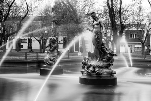 Black and White Photo of Fountain in Town Square
