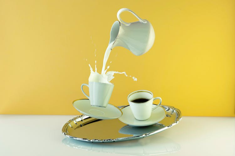 Pouring Milk On A Cup