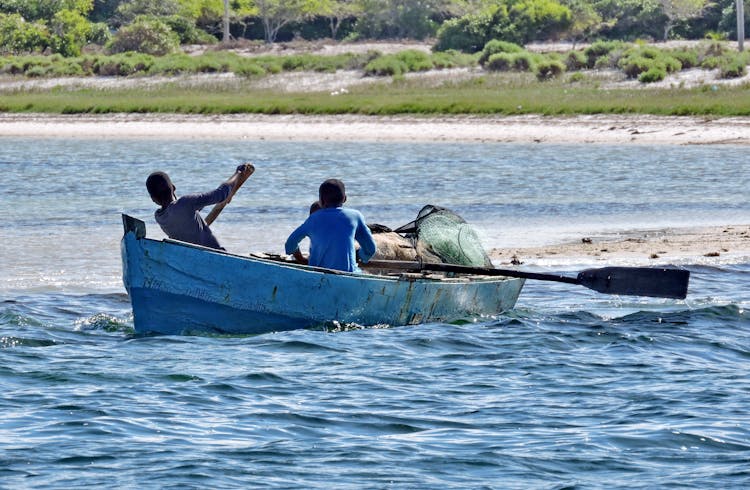 People Riding A Boat