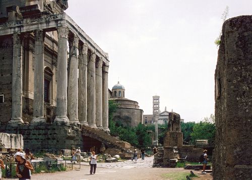 Free Tourists explore the ancient Roman Forum ruins in Rome, Italy, showcasing historic columns and landmarks. Stock Photo