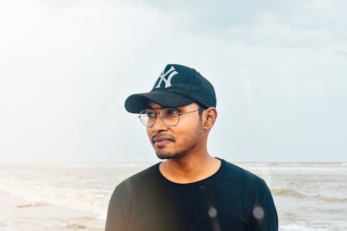 Close Up Photo of Man Wearing Black Cap and Eyeglasses