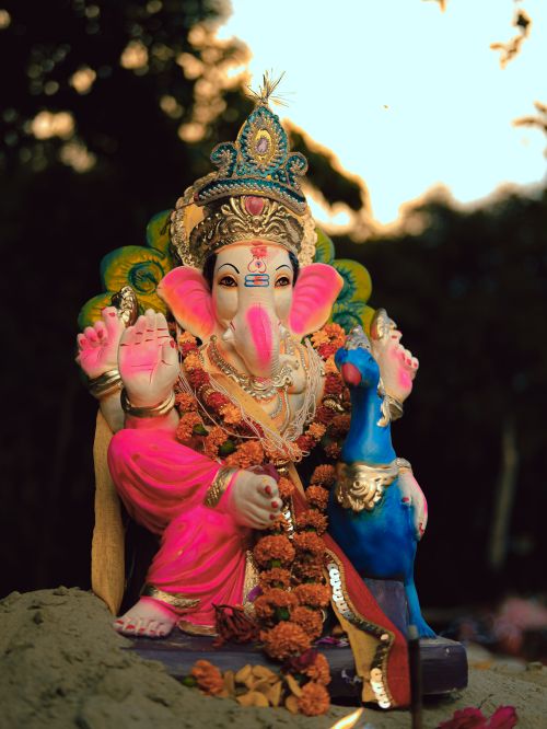 Free Colorful Ganesha statue adorned with flowers and ornaments, capturing vibrant spirituality in Lucknow. Stock Photo