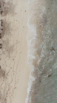 Stunning aerial shot of waves gently lapping the sandy shores of Maasin, Philippines.