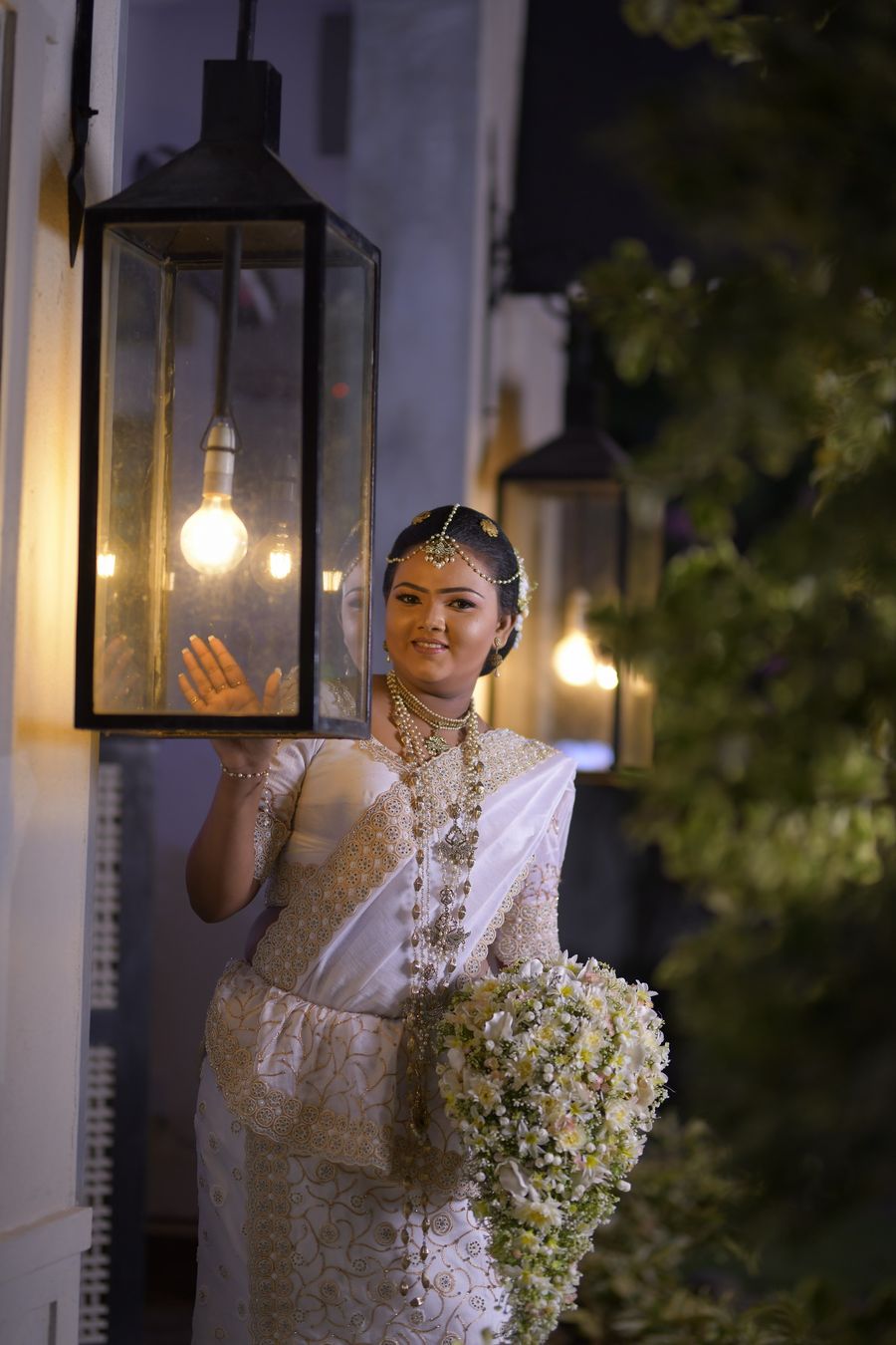Bride at dusk by lantern light after her going-away