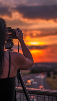 A photographer seizes the breathtaking colors of the sunset, creating a picturesque memory.