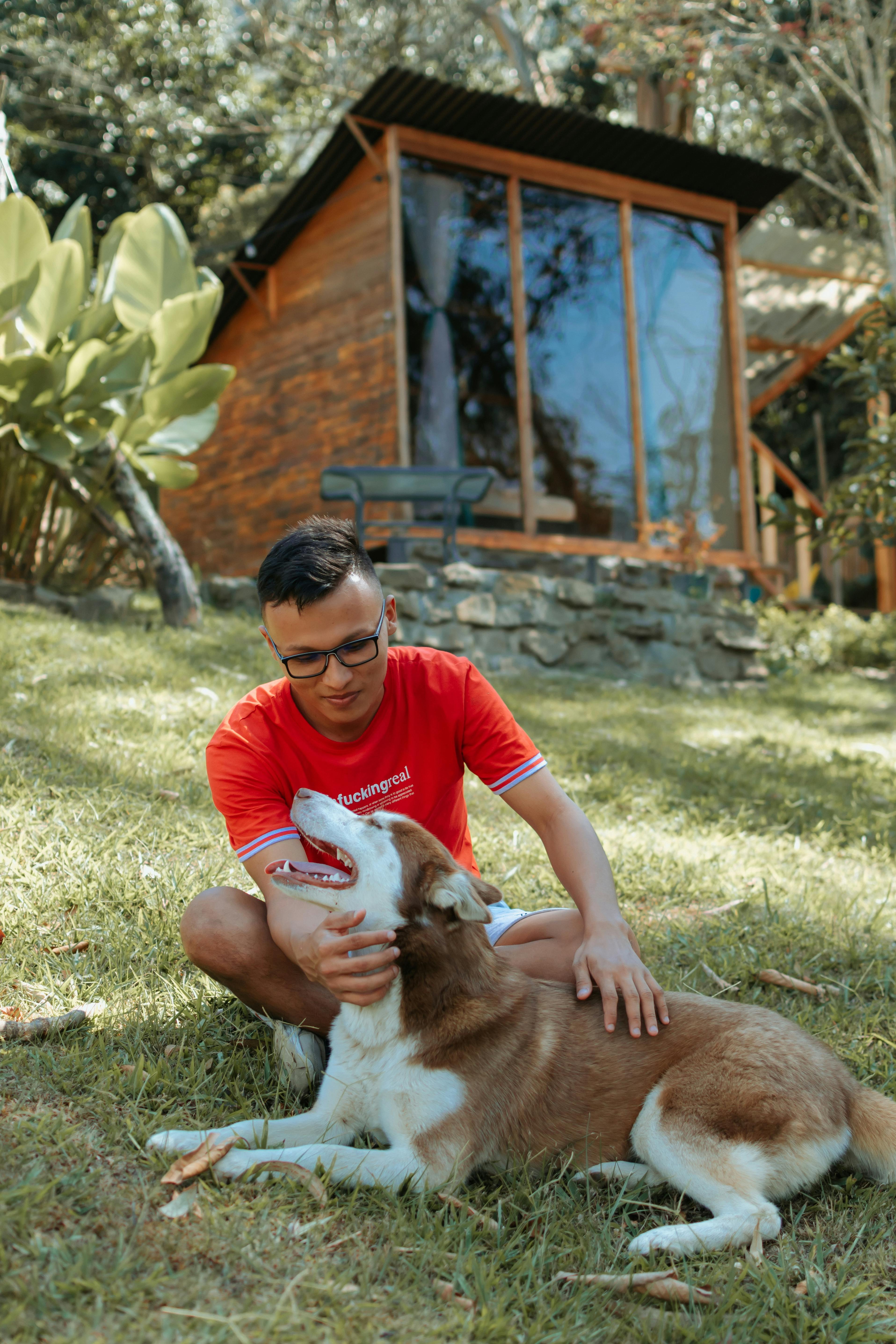 man playing with dog outdoors