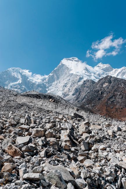Stunning view of snowy peaks and rocky terrain in Huaraz, Peru under a clear blue sky.