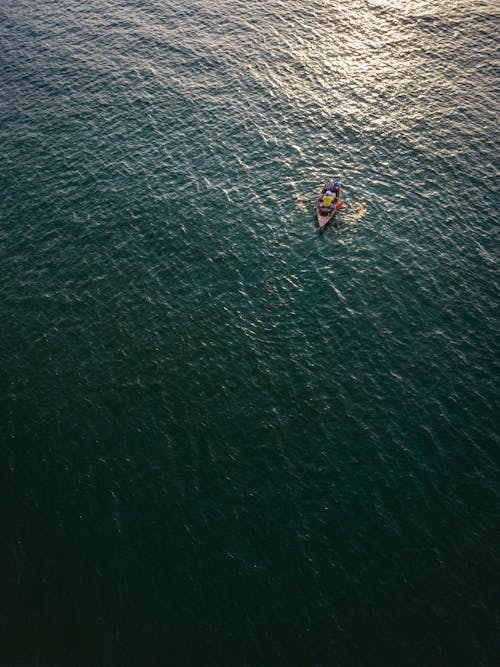 Aerial View of a Person Riding a Boat on the Sea