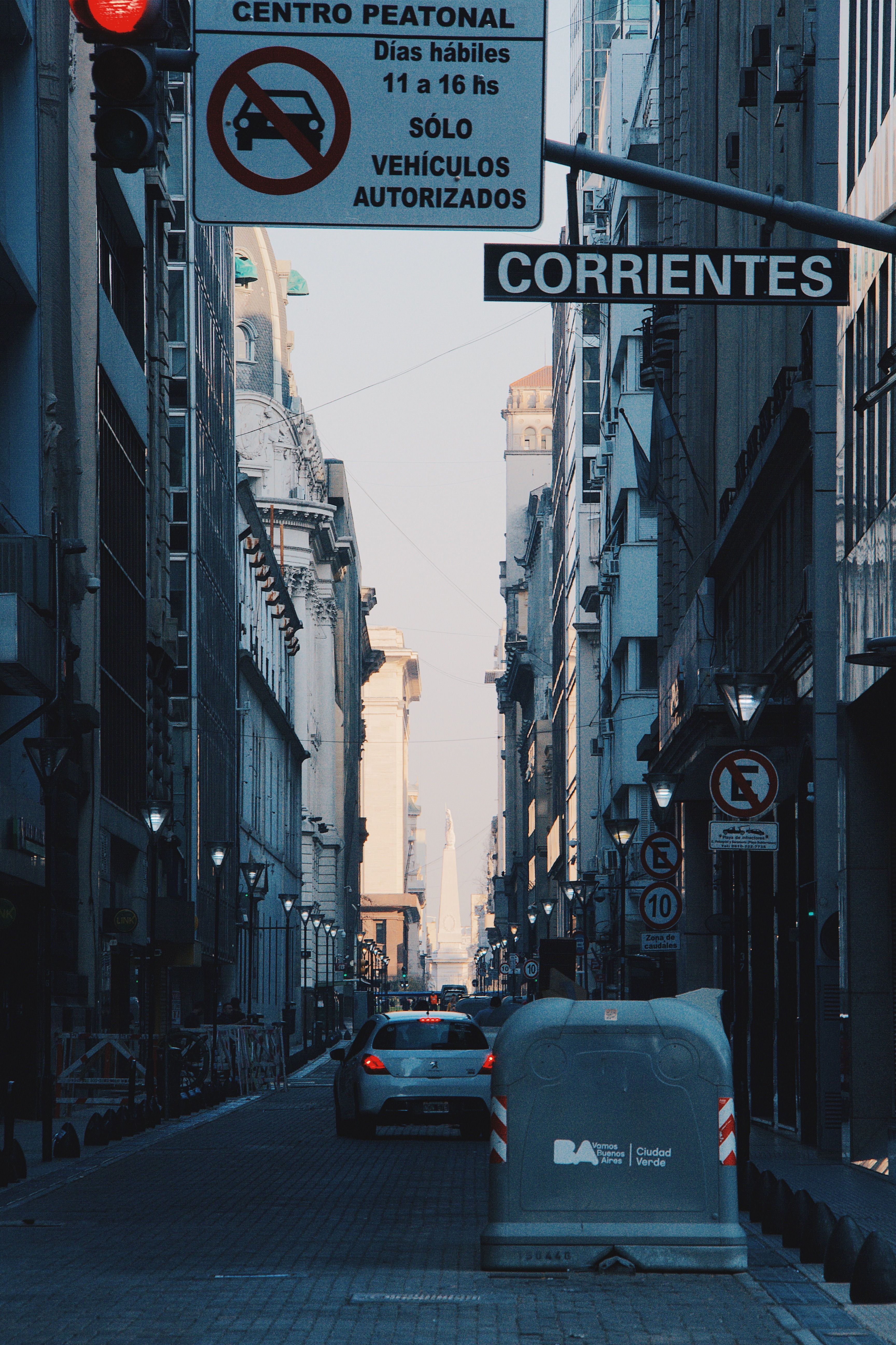 A bustling view of Corrientes street in Buenos Aires, showcasing urban architecture and traffic.