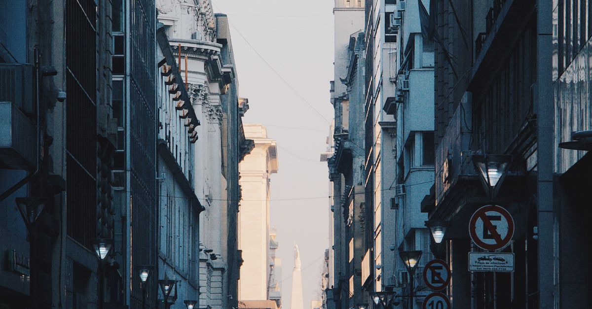 A bustling view of Corrientes street in Buenos Aires, showcasing urban architecture and traffic.