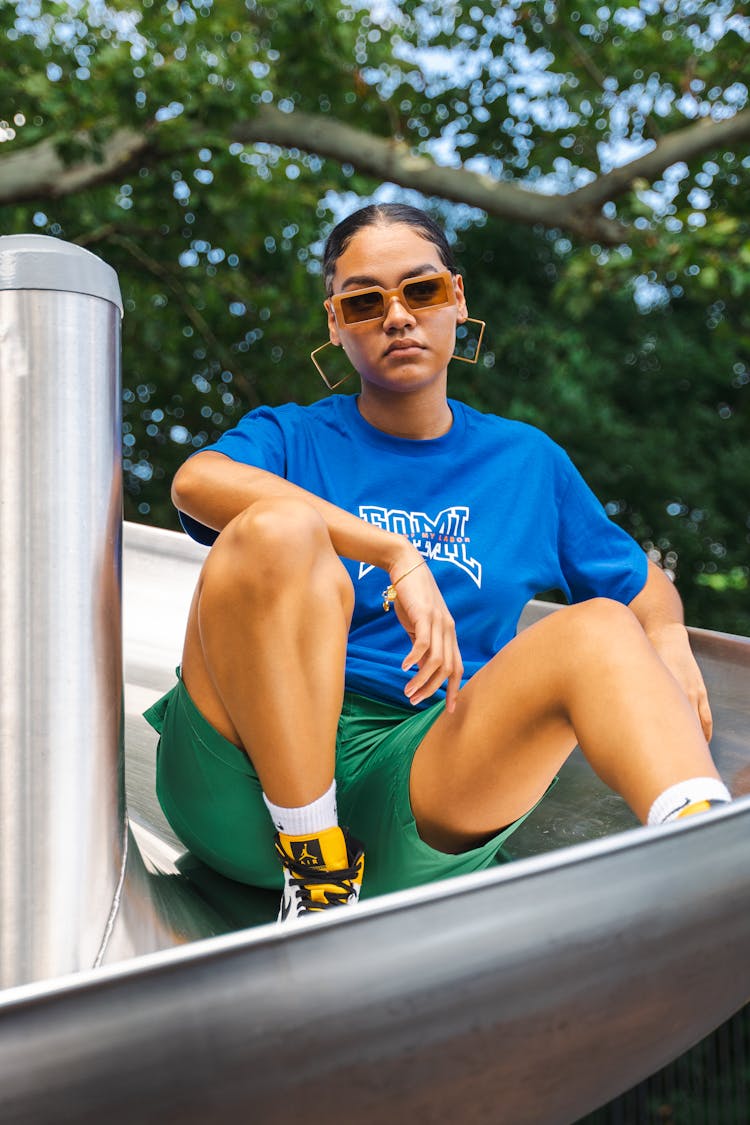 Stylish Woman Sitting On Slide