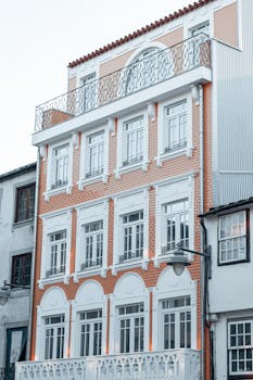 Elegant multi-story building with classic brick and white facade, showcasing architectural details.