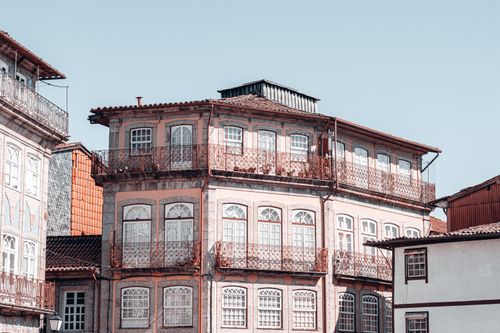 Free A charming historic building facade under a clear blue sky, showcasing European architectural style. Stock Photo