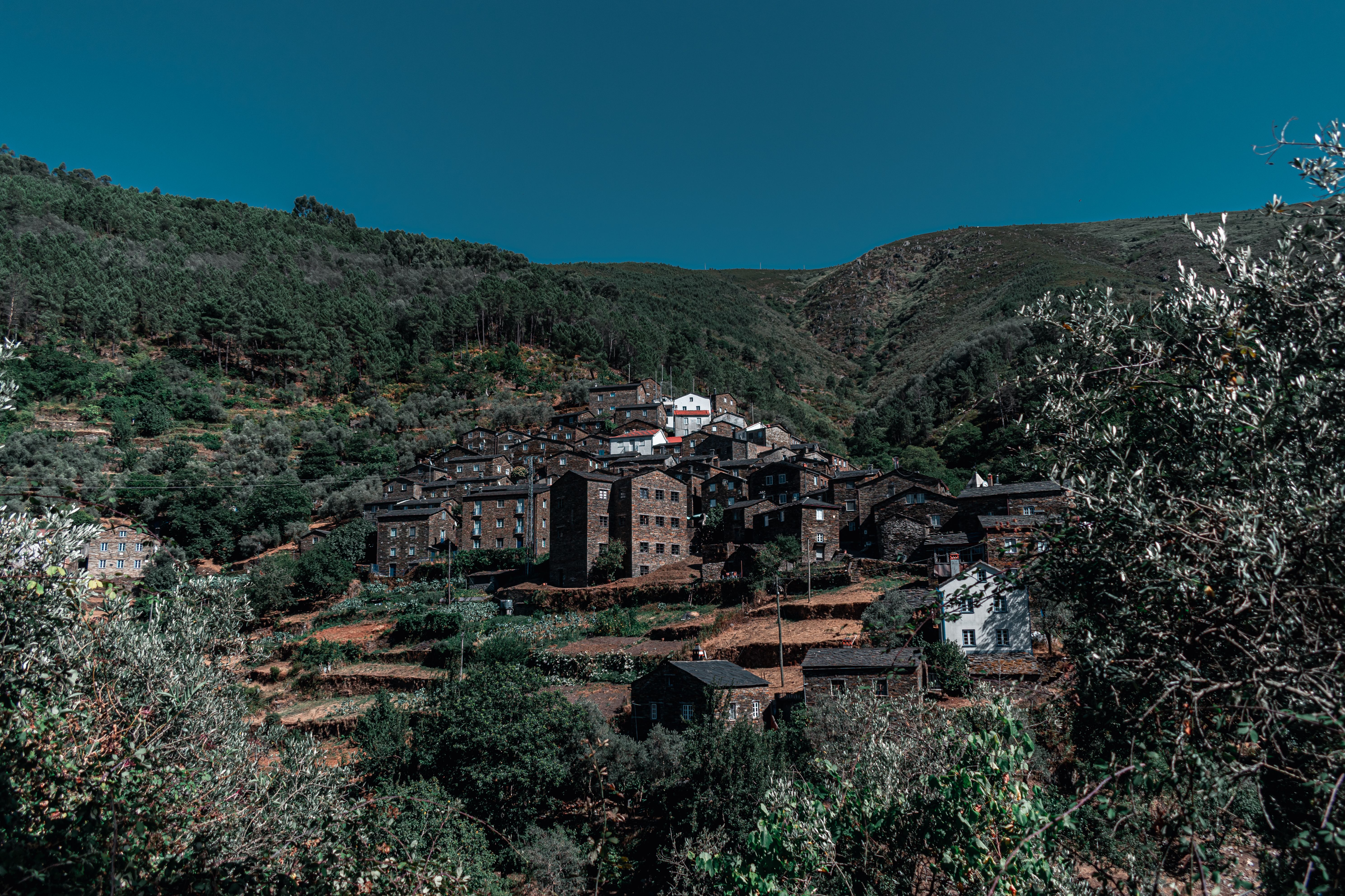 Picturesque mountain village with traditional houses under a clear blue sky.