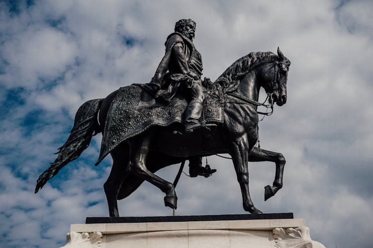 Black Statue Of Man Riding Horse