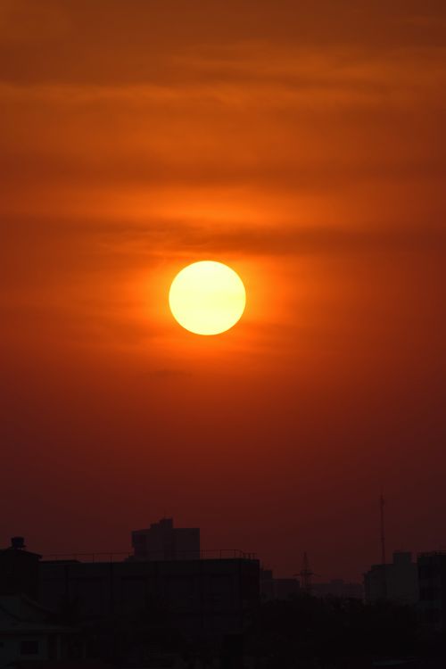 Free Capture of a vibrant sunset casting warm hues over Brasília's cityscape. Stock Photo