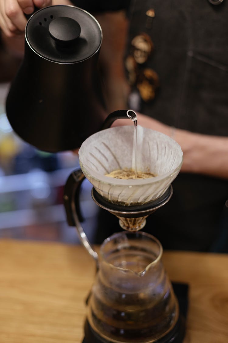 Person Pouring Water On Coffee Filter