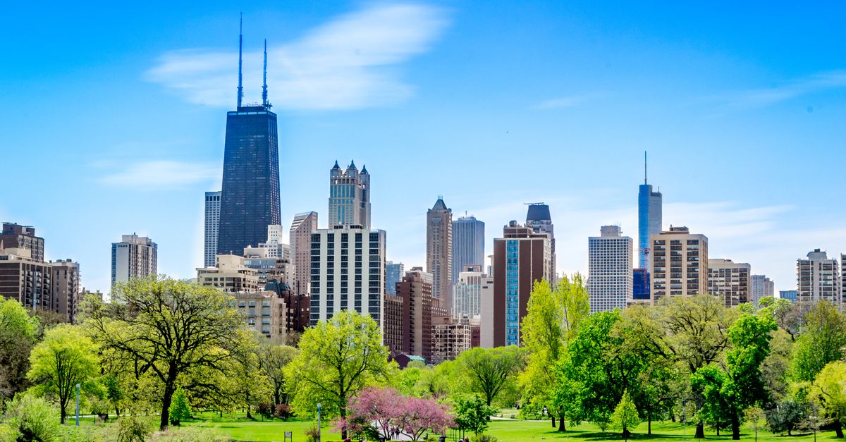 Vibrant Chicago skyline featuring the John Hancock Center and lush park foreground.