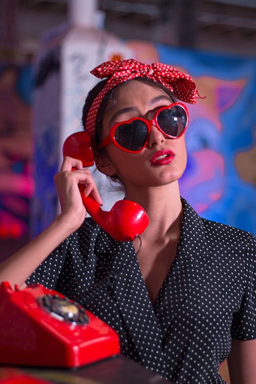 Woman Using Red Rotary Phone
