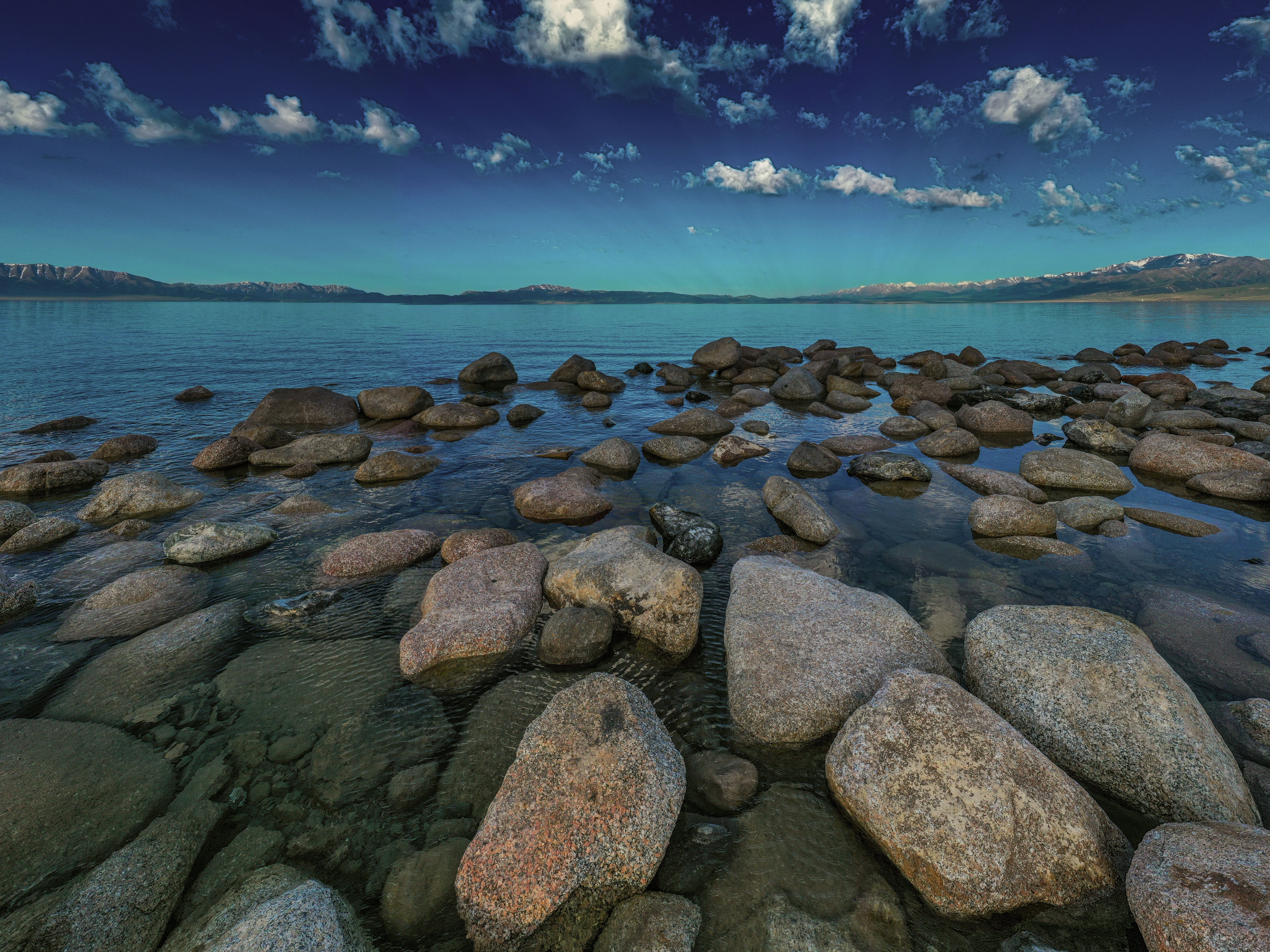 A Rocks on the Sea Under the Blue Sky and White Clouds · Free Stock Photo
