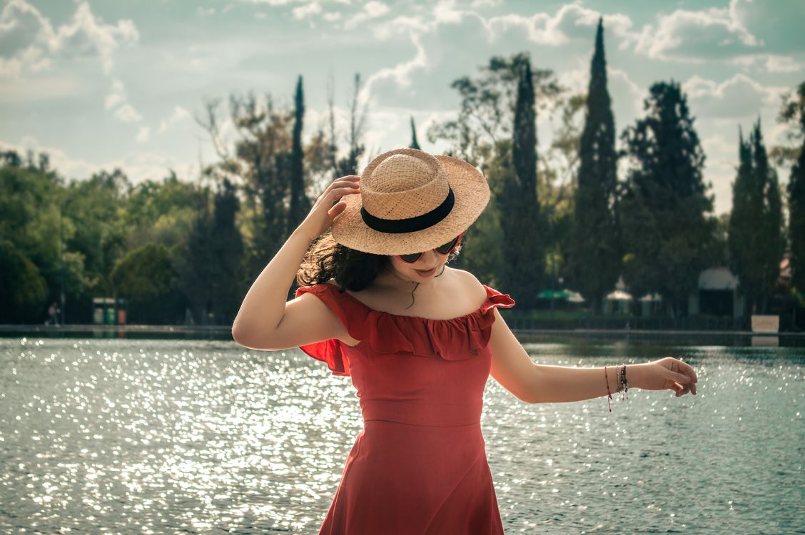 A Woman Wearing a Red Dress and a Straw Hat · Free Stock Photo