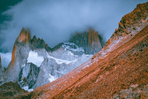 Rocky Mountain with Snow Under Clouds