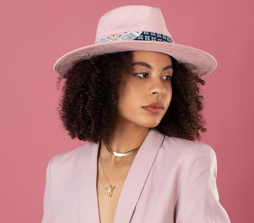 A Portrait of a Woman Wearing a Pink Blazer and a Pink Hat