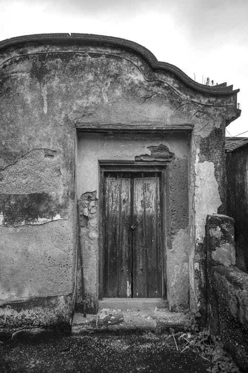 Black and White Photo of the Door of an Abandoned House