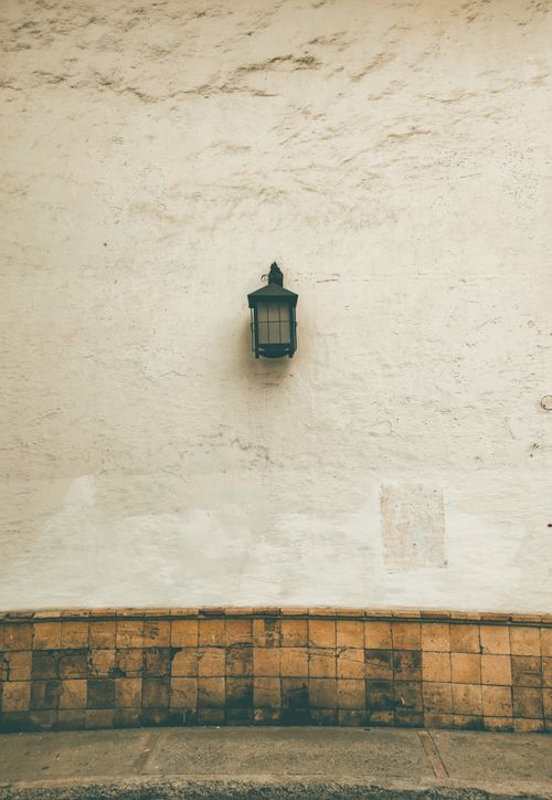 Free A classic lantern adorns a rustic textured wall, capturing the essence of Colombian architecture. Ideal for design inspiration. Stock Photo